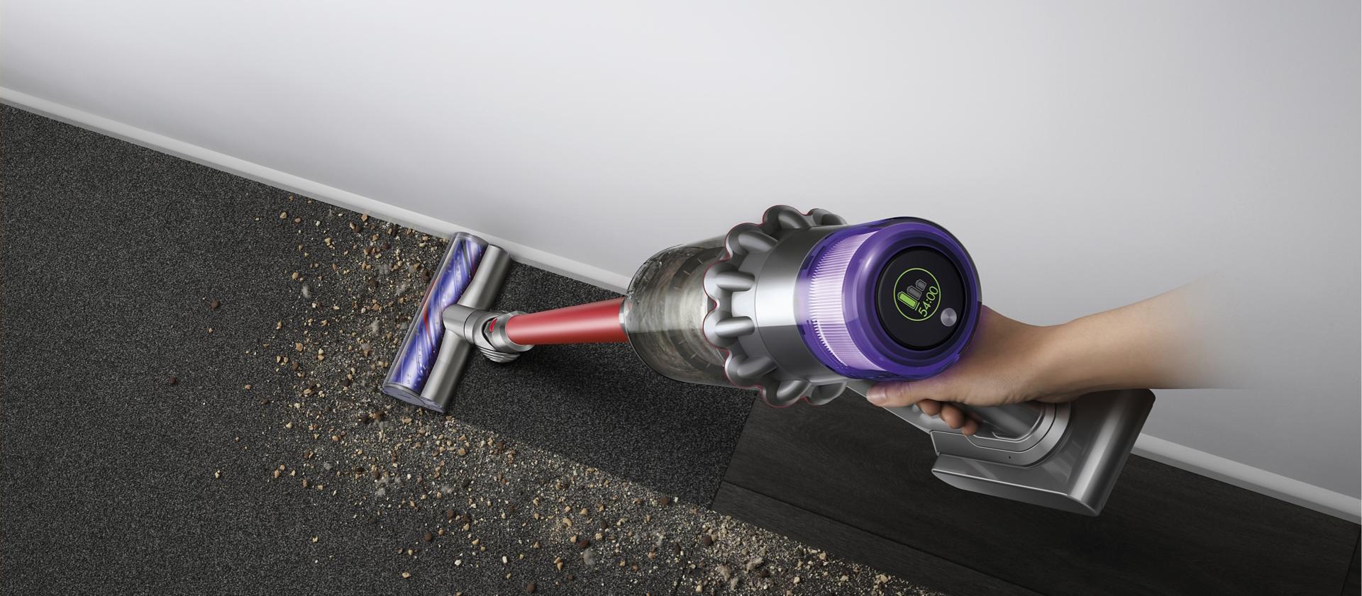 Close-up of hand holding the Dyson V15 Detect vacuum