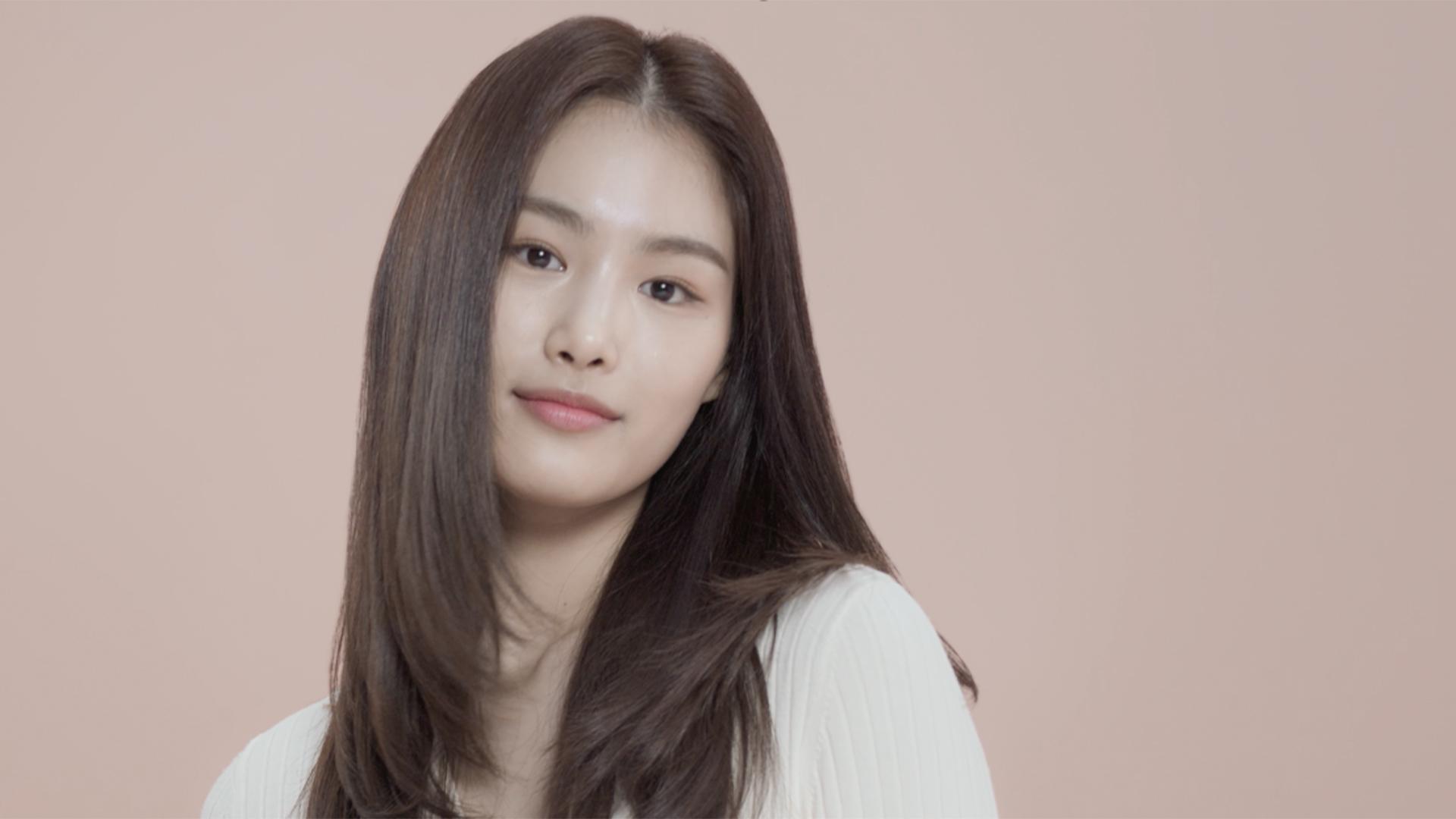 A still of a model with styled long hair.