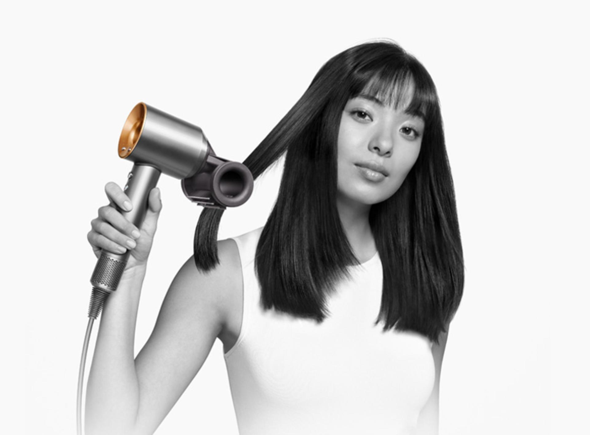 Model using the Dyson Supersonic hair dryer