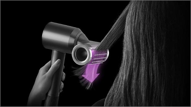 A tress of hair is styled using the Dyson Supersonic with Flyaway smoother attachment in Smoothing mode.