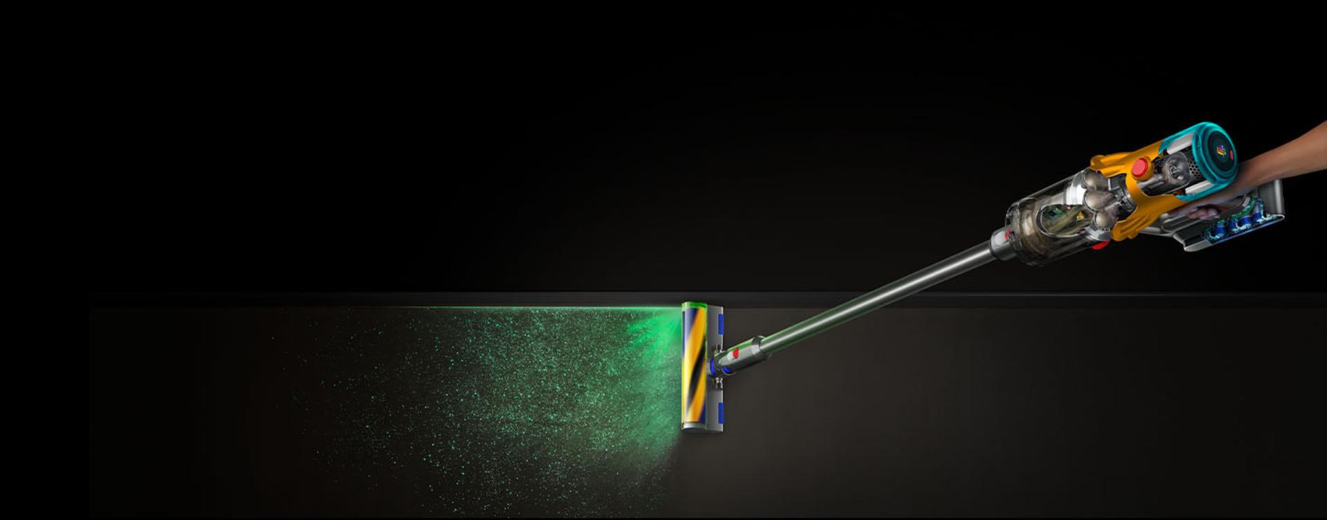 The Dyson V12s Detect Slim Submarine wet and dry vacuum cleaner illuminates and cleans dust from a hard floor.