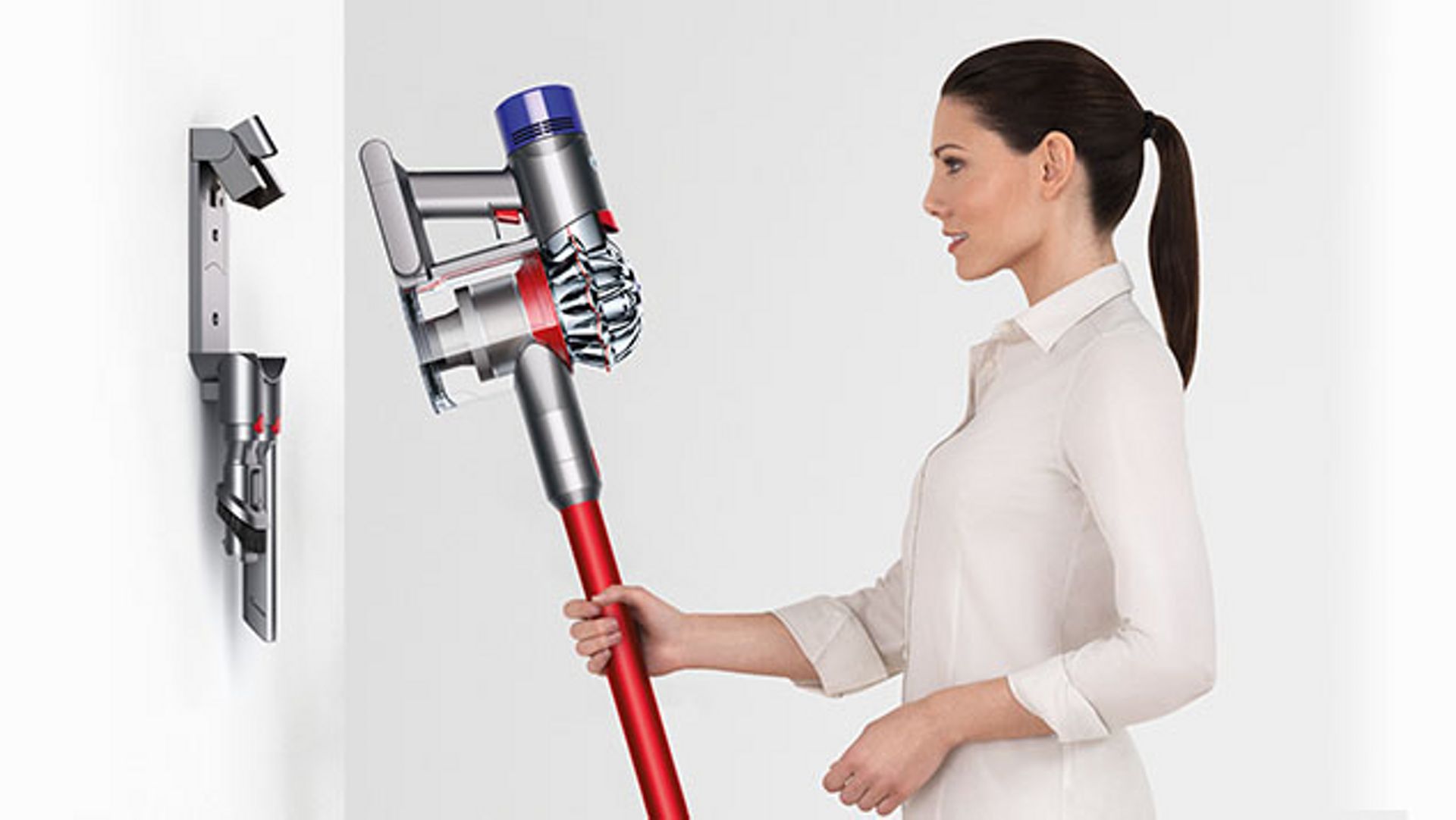 Woman using Dyson V8 Absolute vacuum docking station