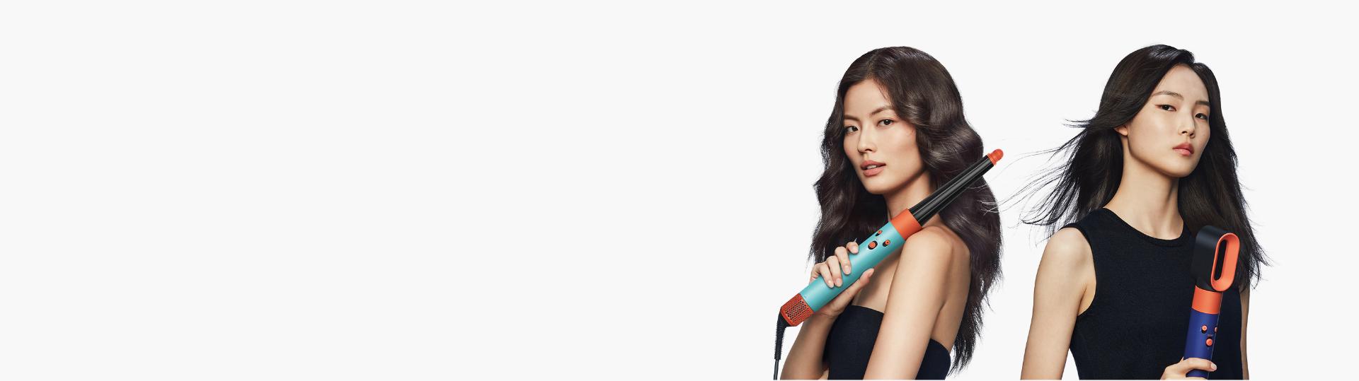 A model is curling her hair with an Airwrap ID multi-styler and dryer.