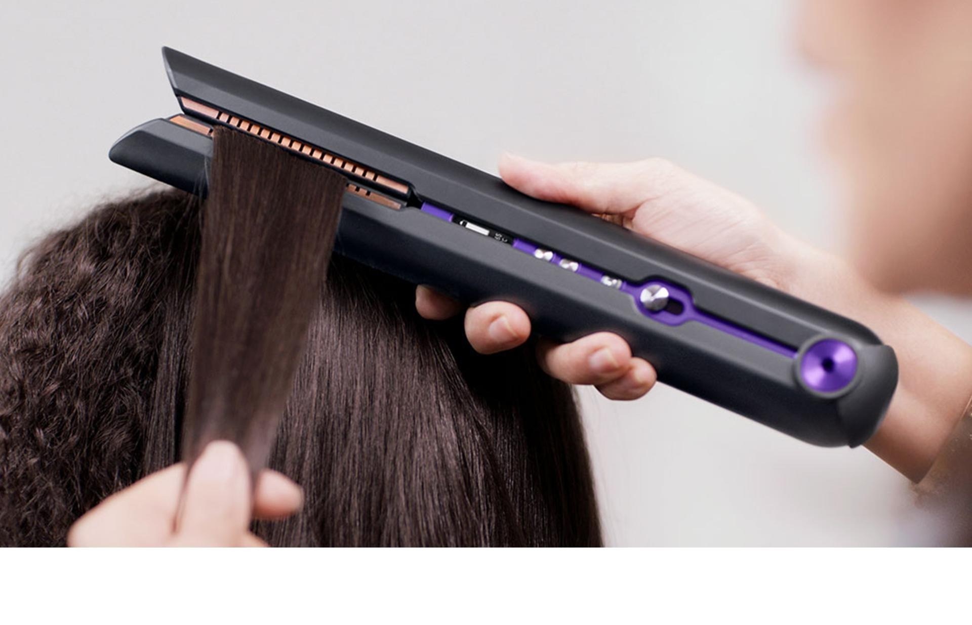 Professional stylist using the Dyson Corrale hair straightener
