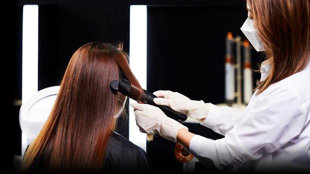 Dyson stylist helping someone with a demo