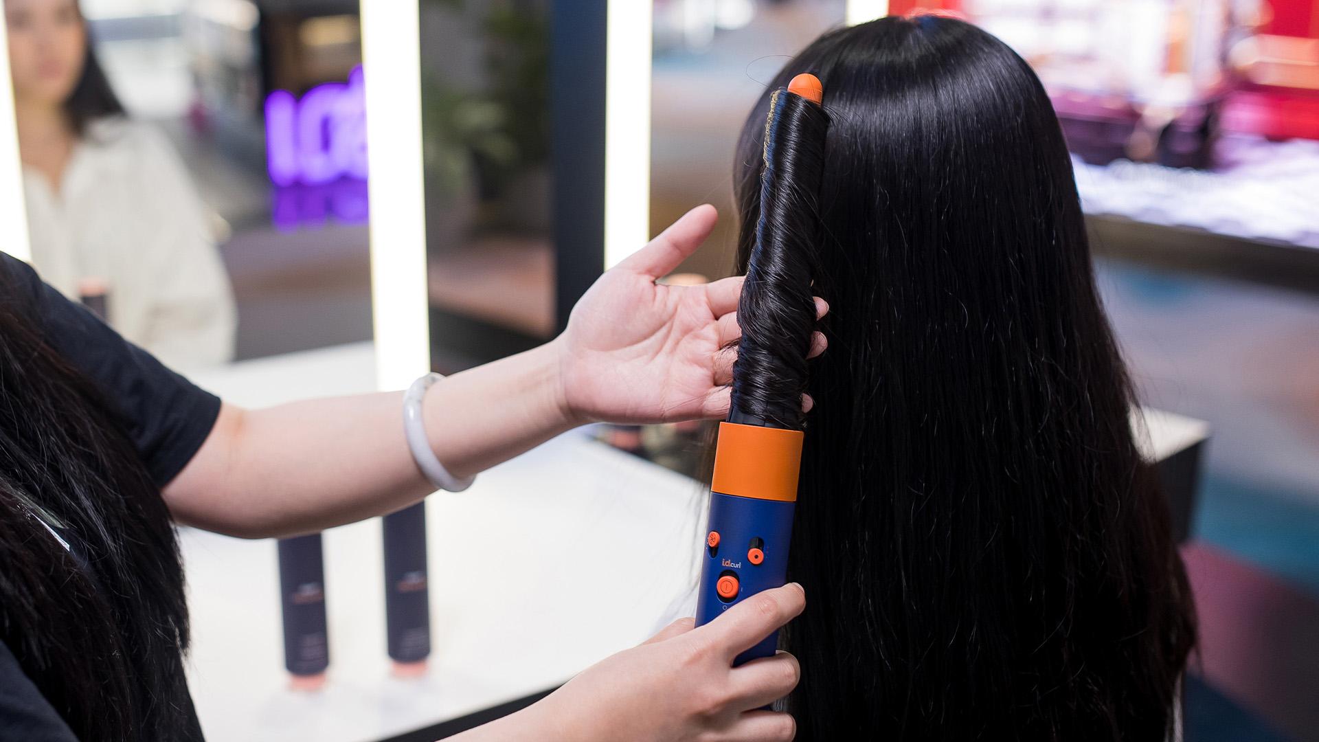 Dyson Expert using Dyson Corrale hair straightener on a client