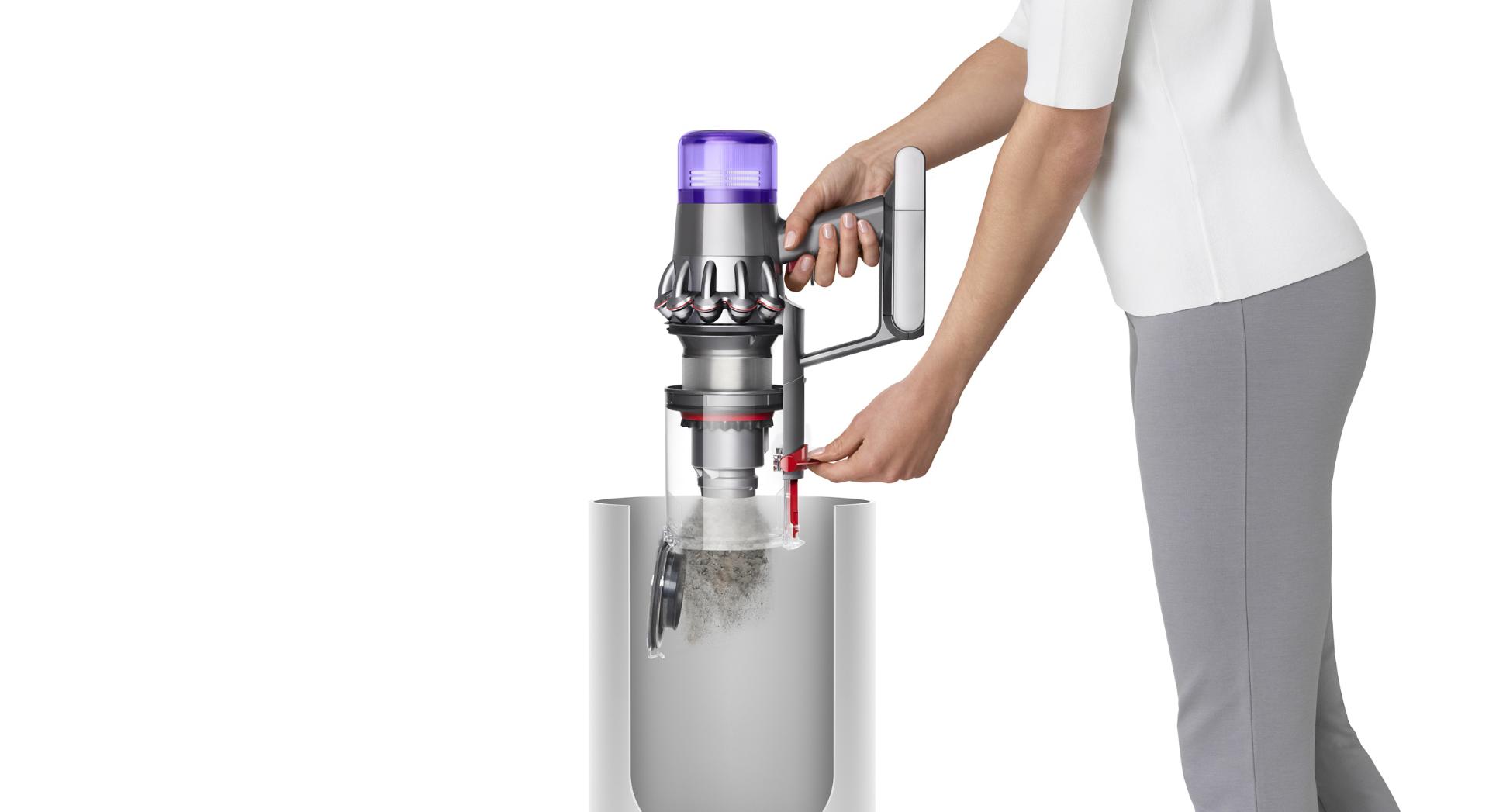 Woman emptying Dyson V11™ vacuum into bin