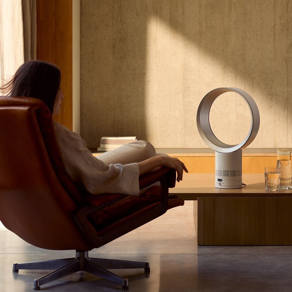 The Dyson Cool CF1 delivers a cool breeze to a person in a chair.