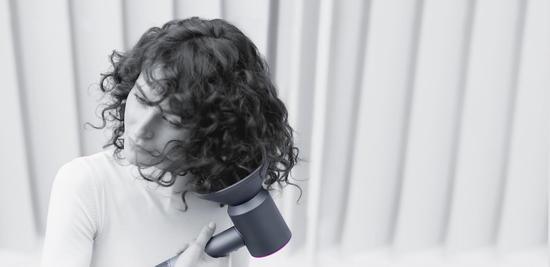 Woman drying her hair with Dyson supersonic