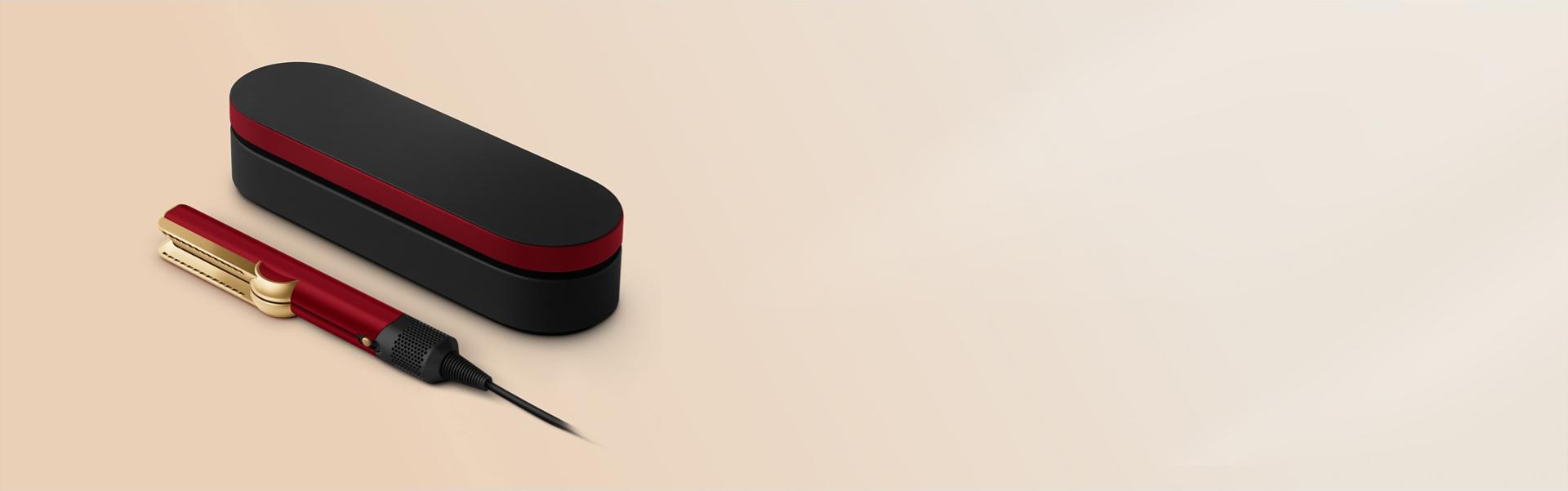 The Dyson Airstrait straightener and Presentation case in the Red velvet and gold colourway.