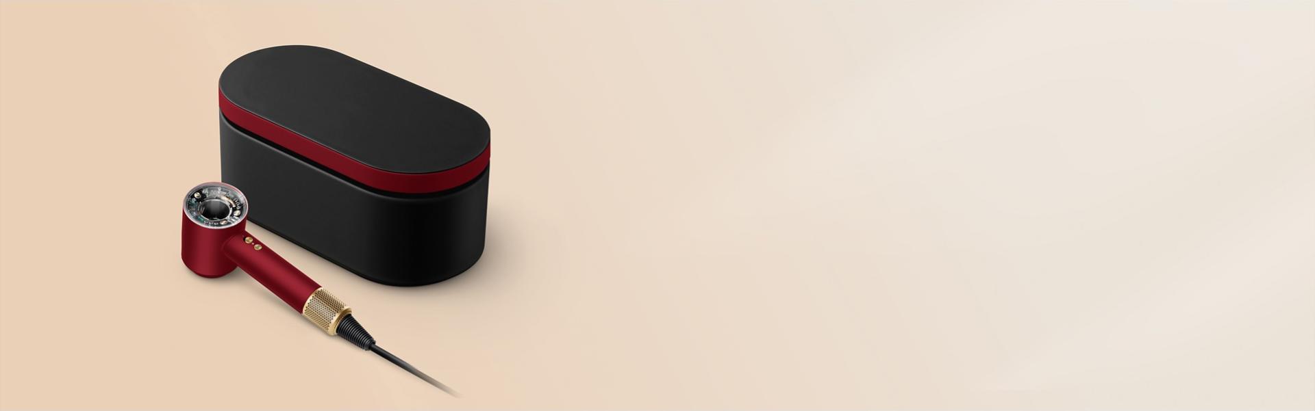 The Dyson Supersonic Nural hair dryer and Presentation case in the Red velvet and gold colourway.