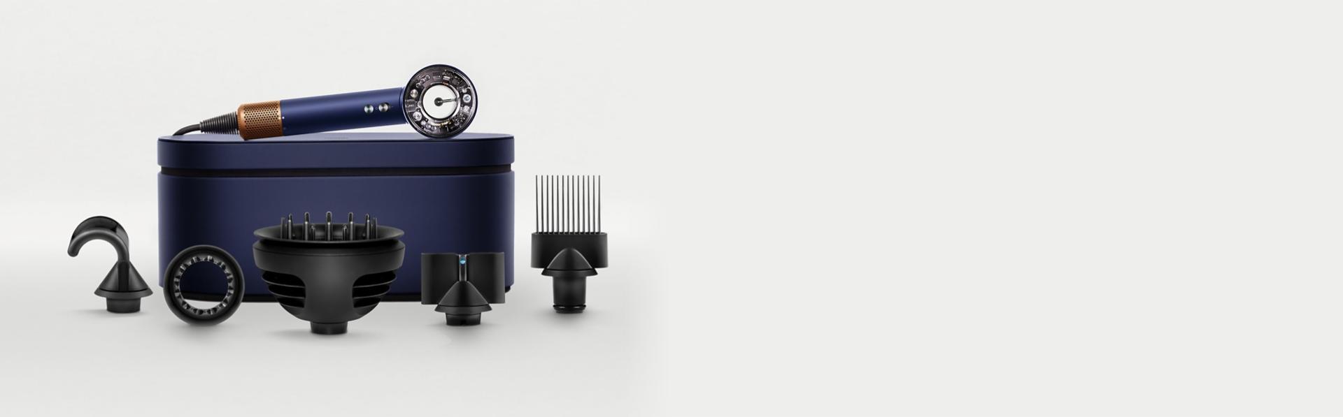 The Dyson Supersonic Nural hair dryer on a Presentation case behind a range of accessories.