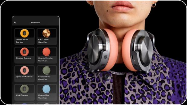An owner with the Dyson OnTrac headphones resting round their neck with the MyDyson app showing all the colourways available.
