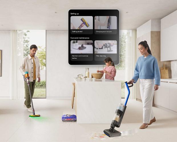 Owners cleaning their home with Dyson technology with the MyDyson app on display showing how to set up their machines.