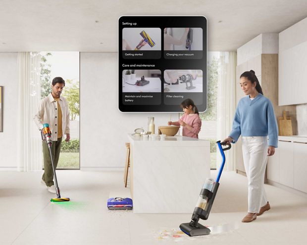 Owners cleaning their home with Dyson technology with the MyDyson app on display showing how to set up their machines.