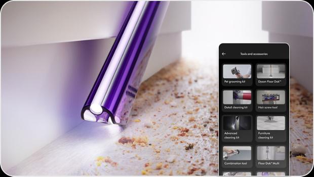 An owner vacuuming between furniture with the MyDyson app showing varying attachments for their Dyson vacuum cleaner.