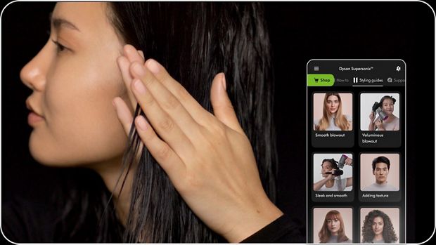 Model styling hair with Dyson Chitosan styling range next to a screen on the MyDyson app which suggests styling guides.