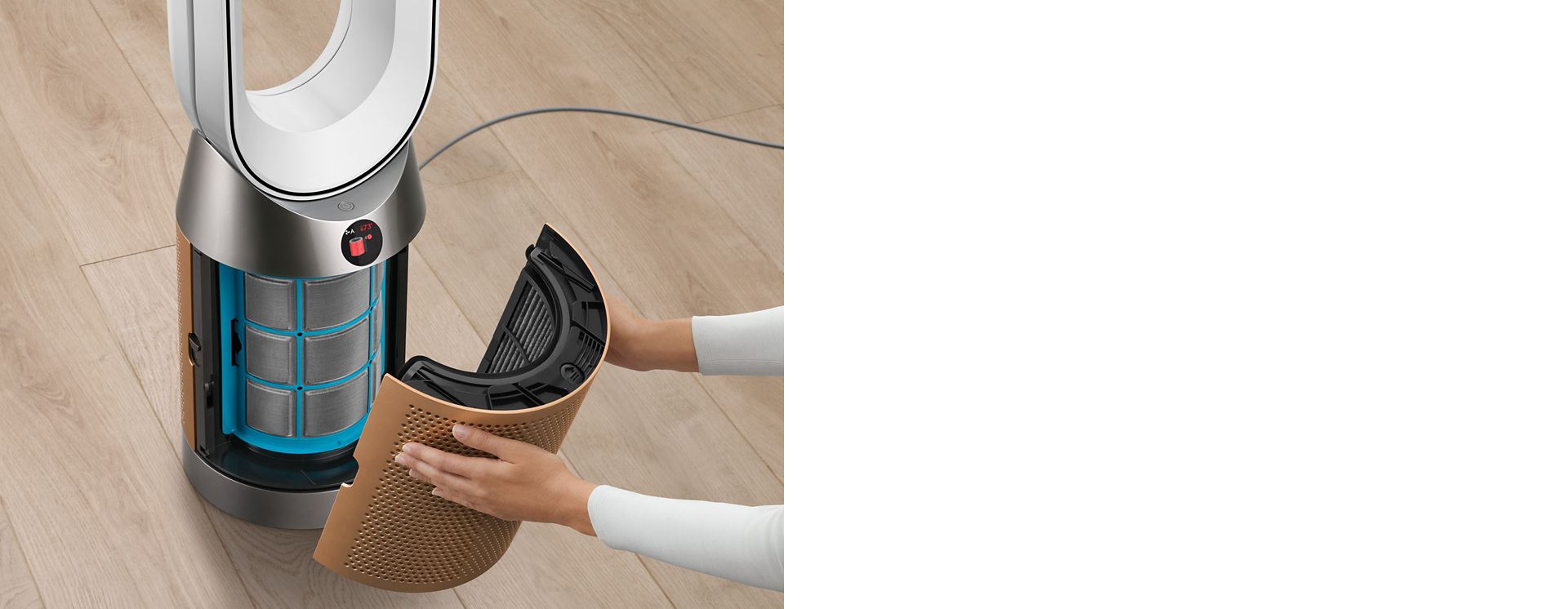 A person removing the shroud on the purifier to change the filter