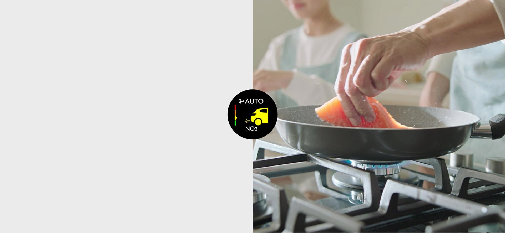 Close-up of a pan on a gas stove cooking fish.