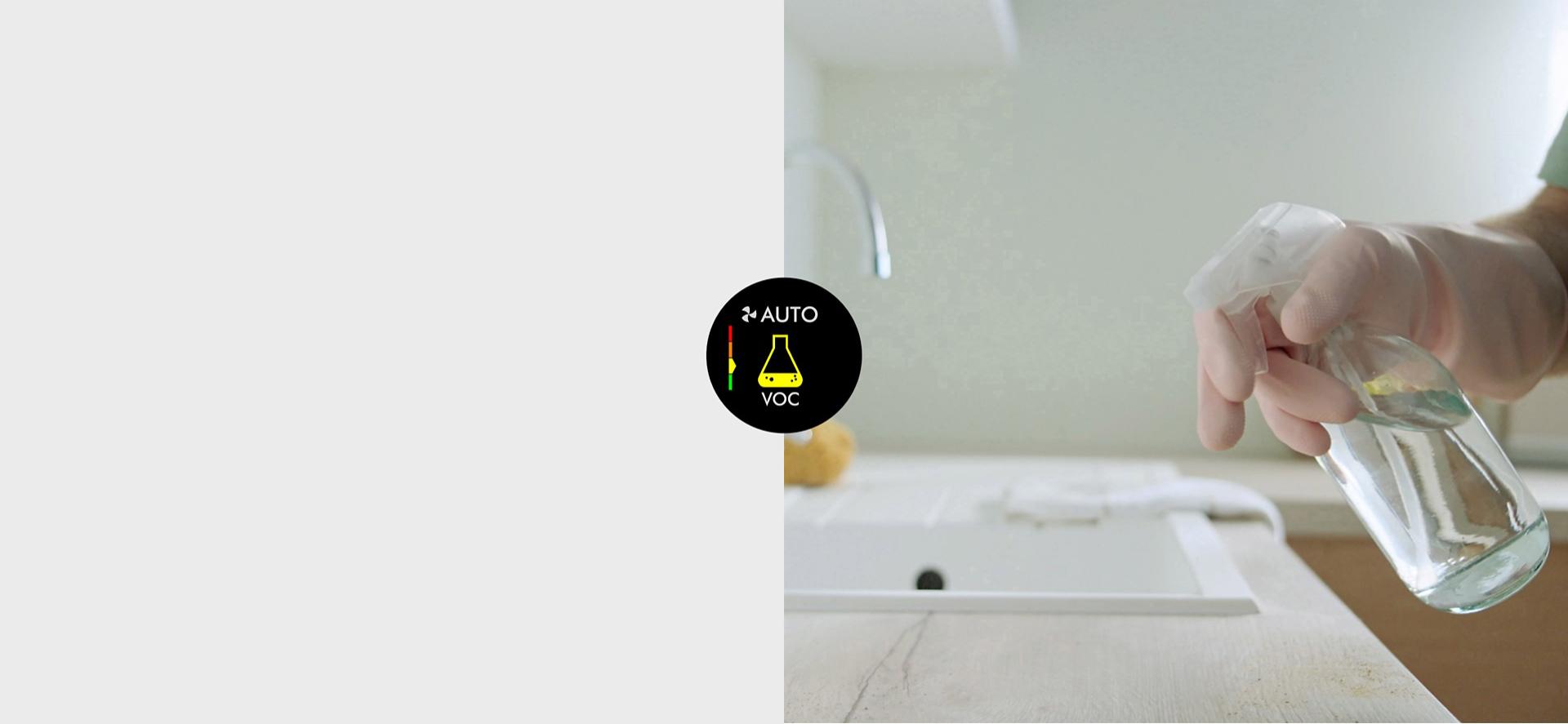 A hand sprays cleaning products from a bottle.