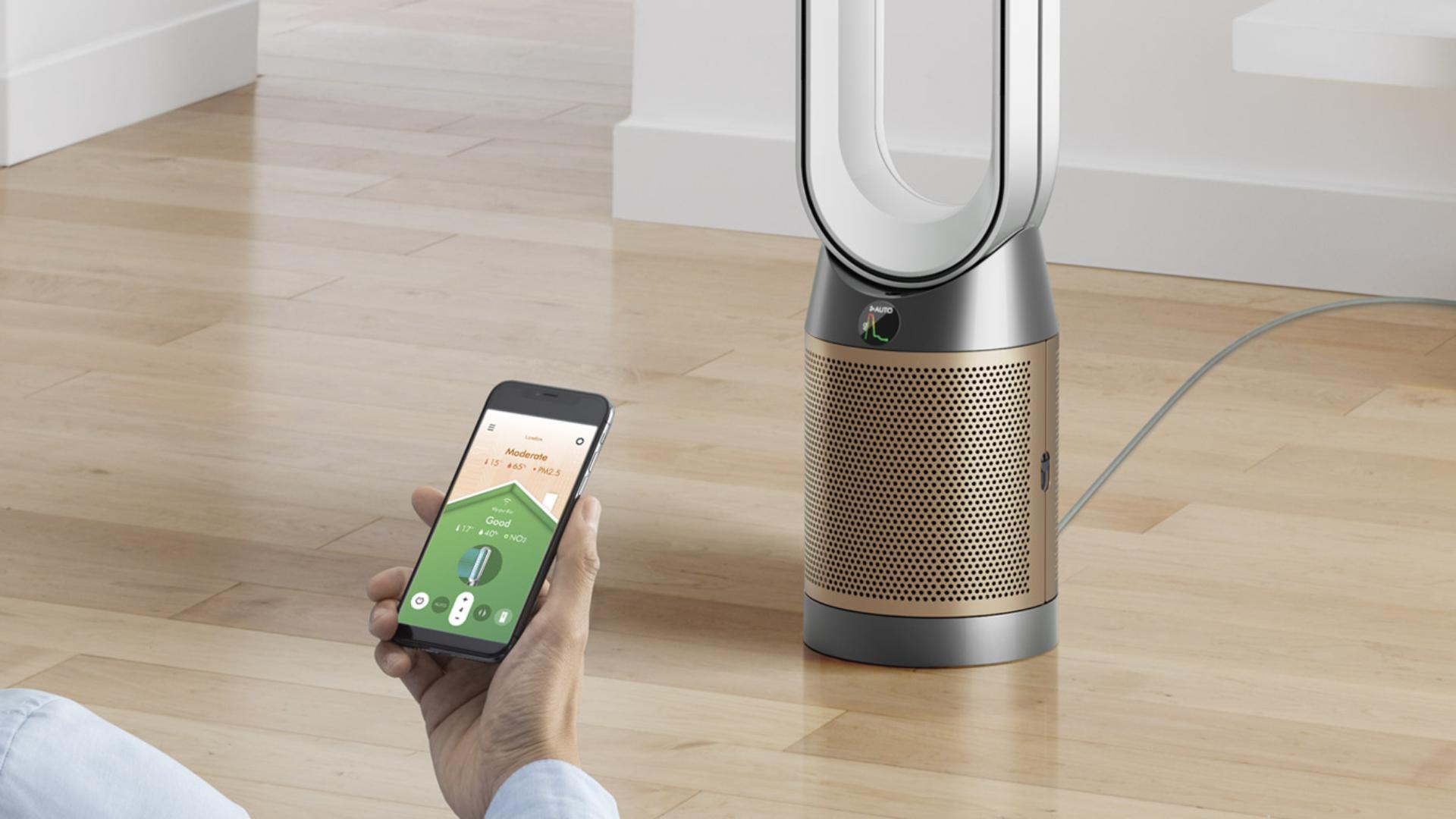 Person operating a purifier using the MyDyson app on a mobile device.