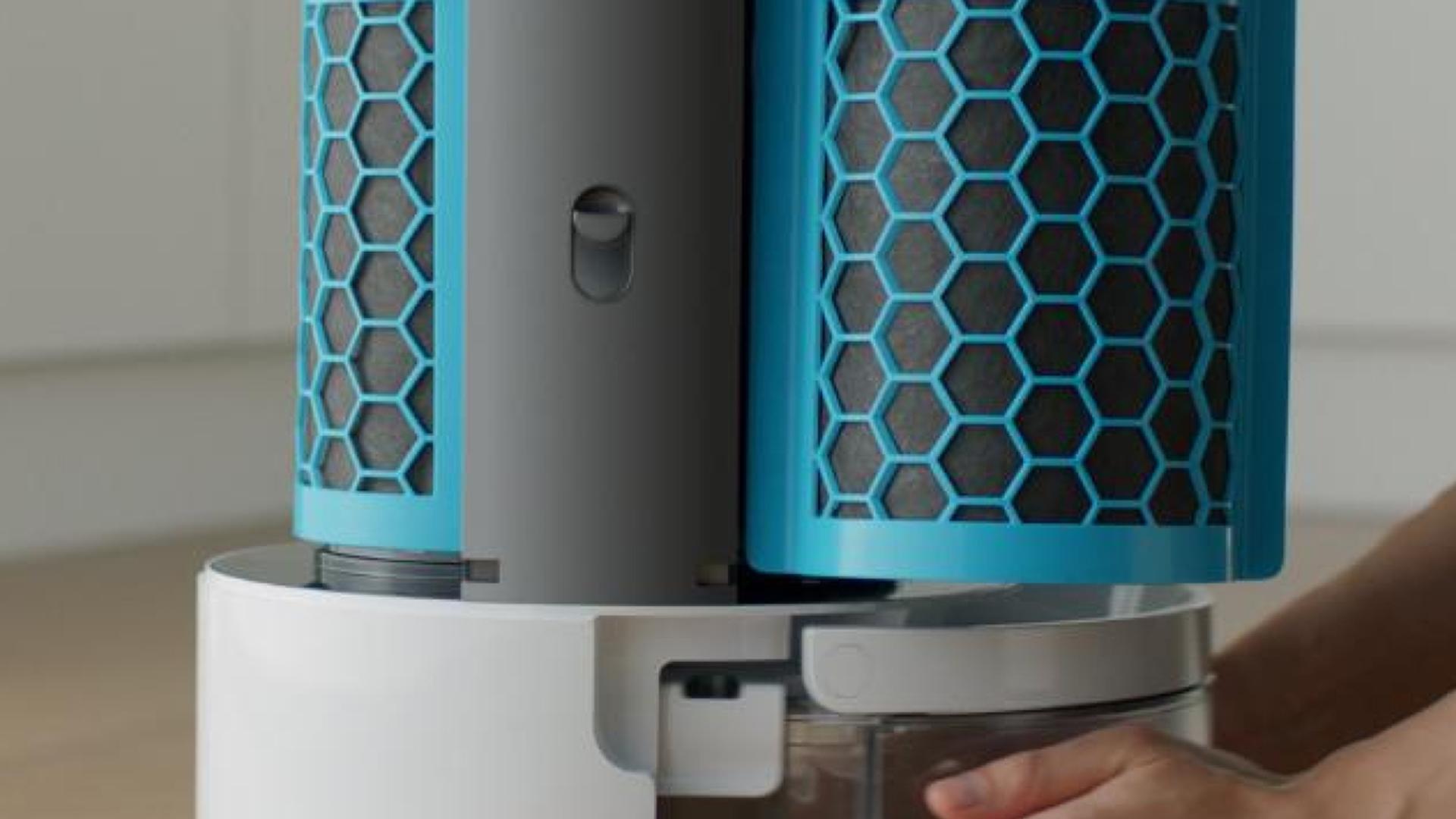 A user removing the water tank for cleaning.