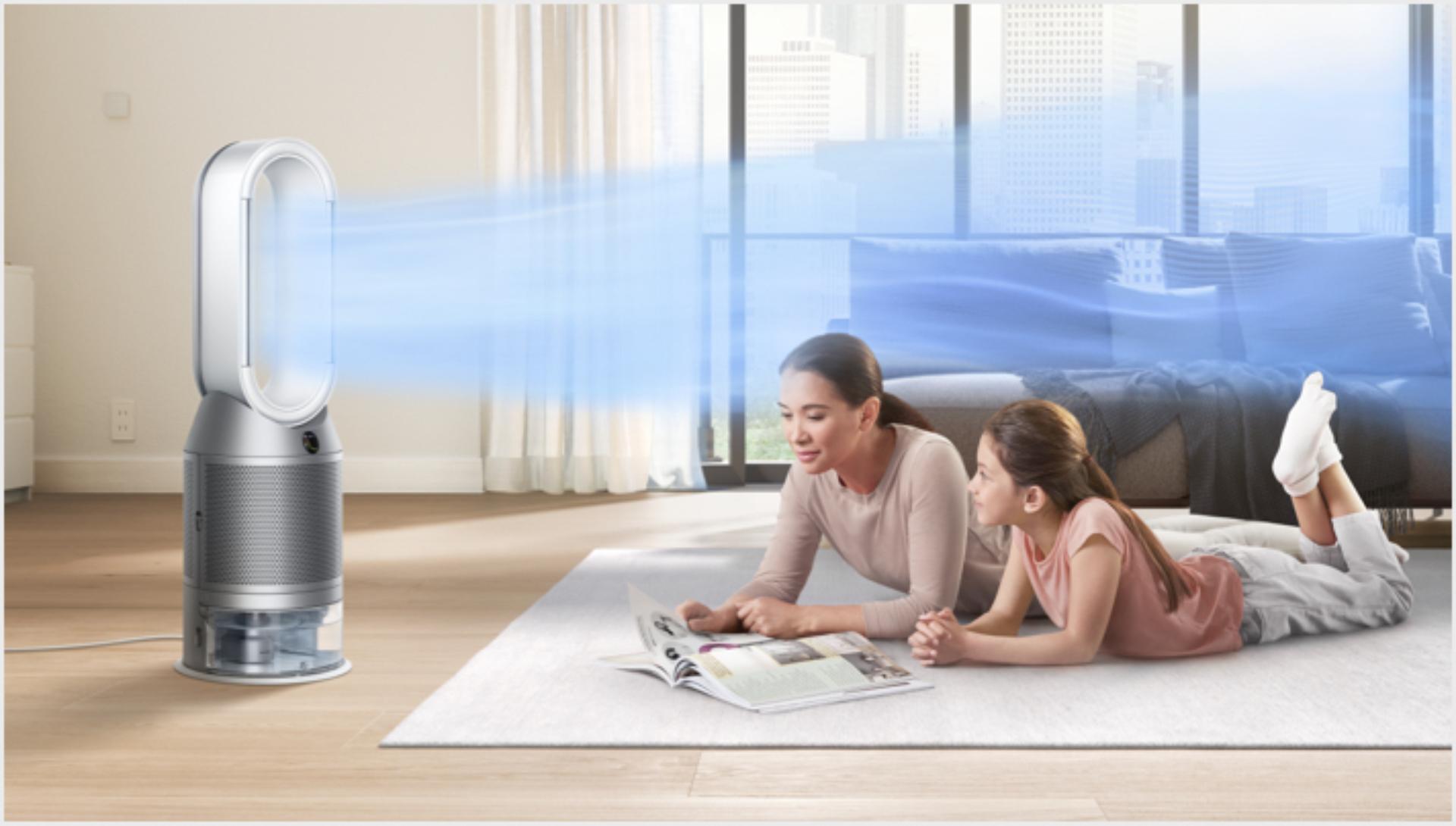 Mother and daughter lying on a rug with Dyson purifier humidifier cooling them