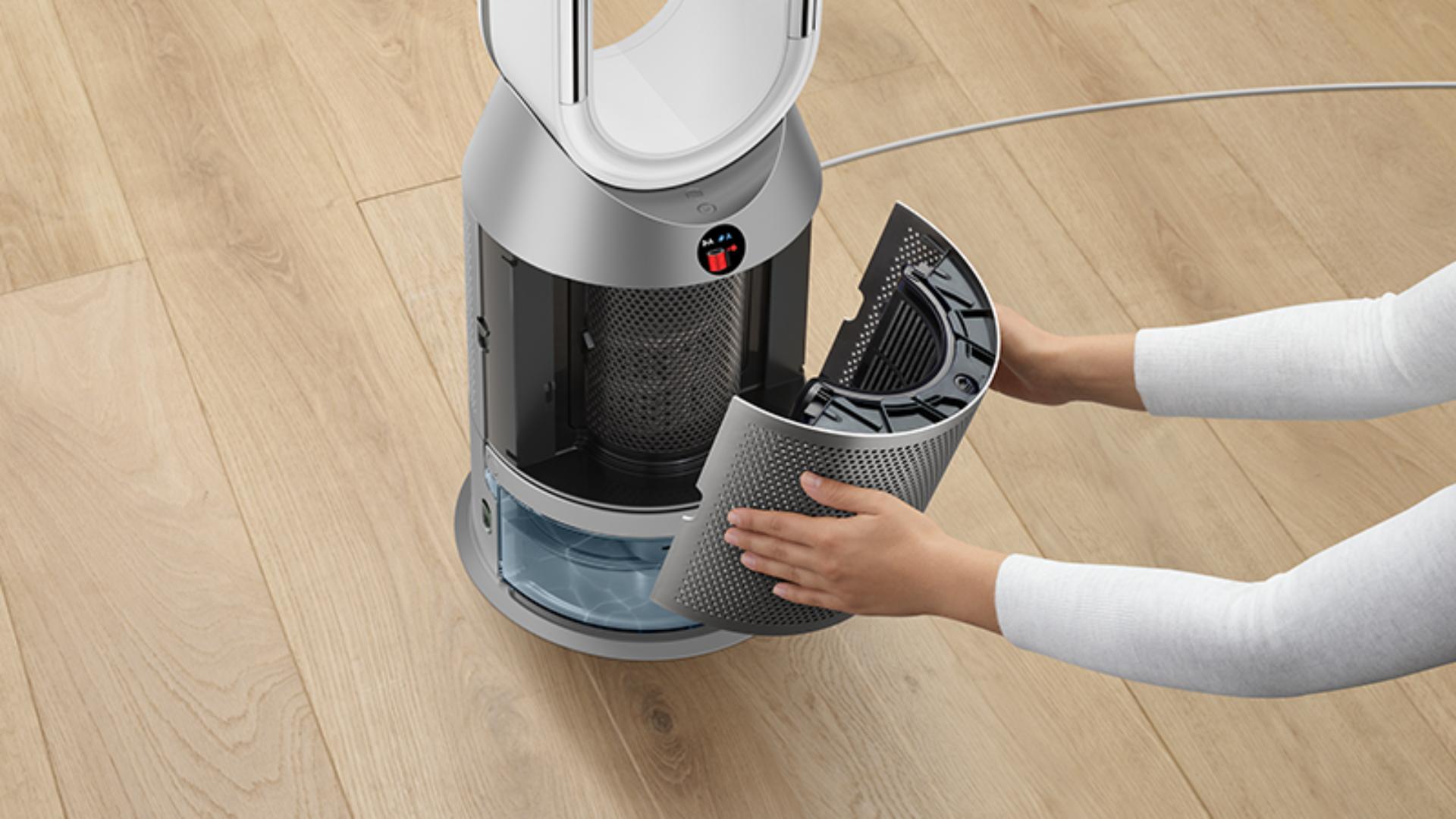 Woman removing filter from the Dyson purifier humidifier