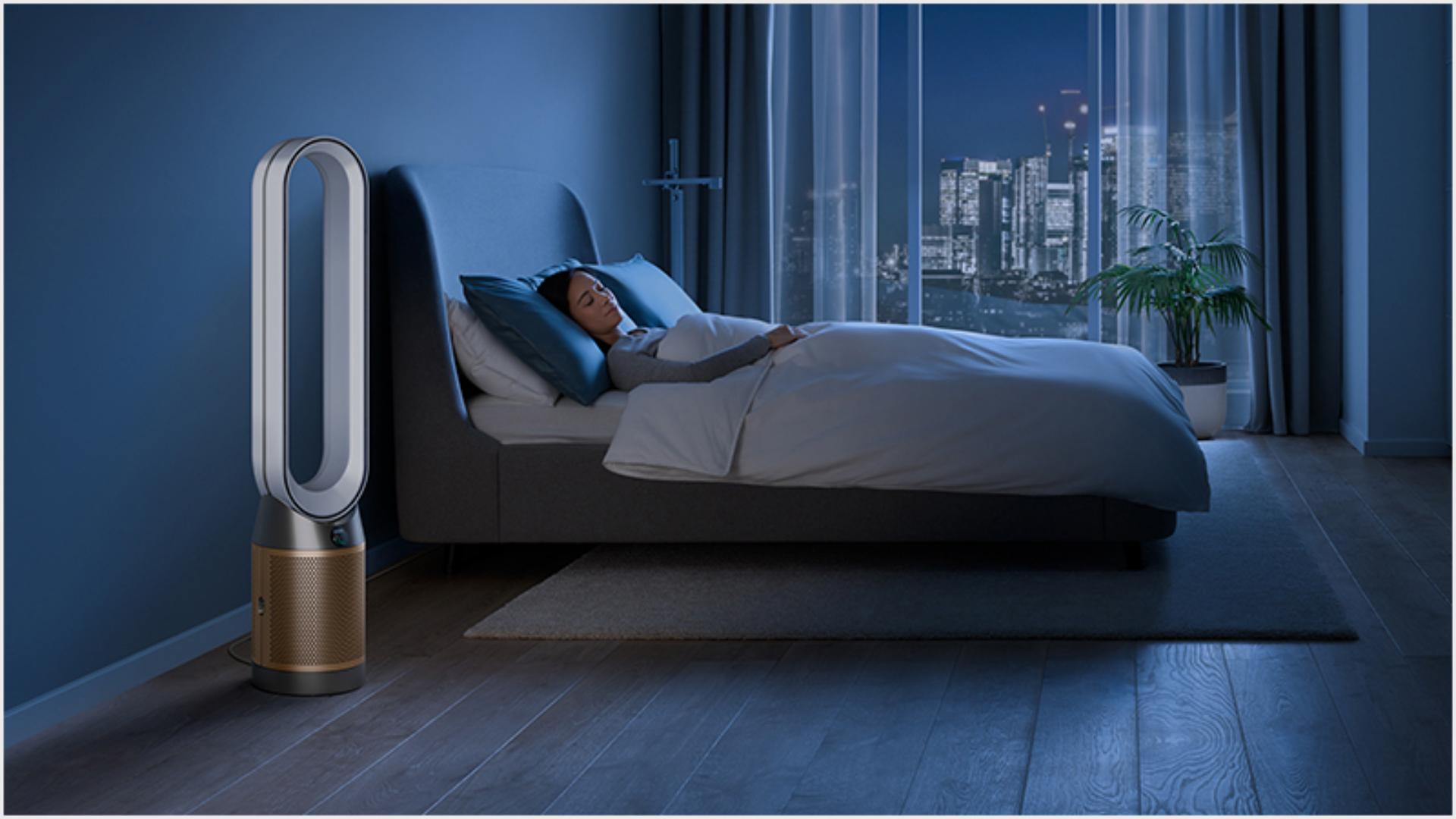 Dyson purifier in a dark bedroom with someone sleeping peacefully 