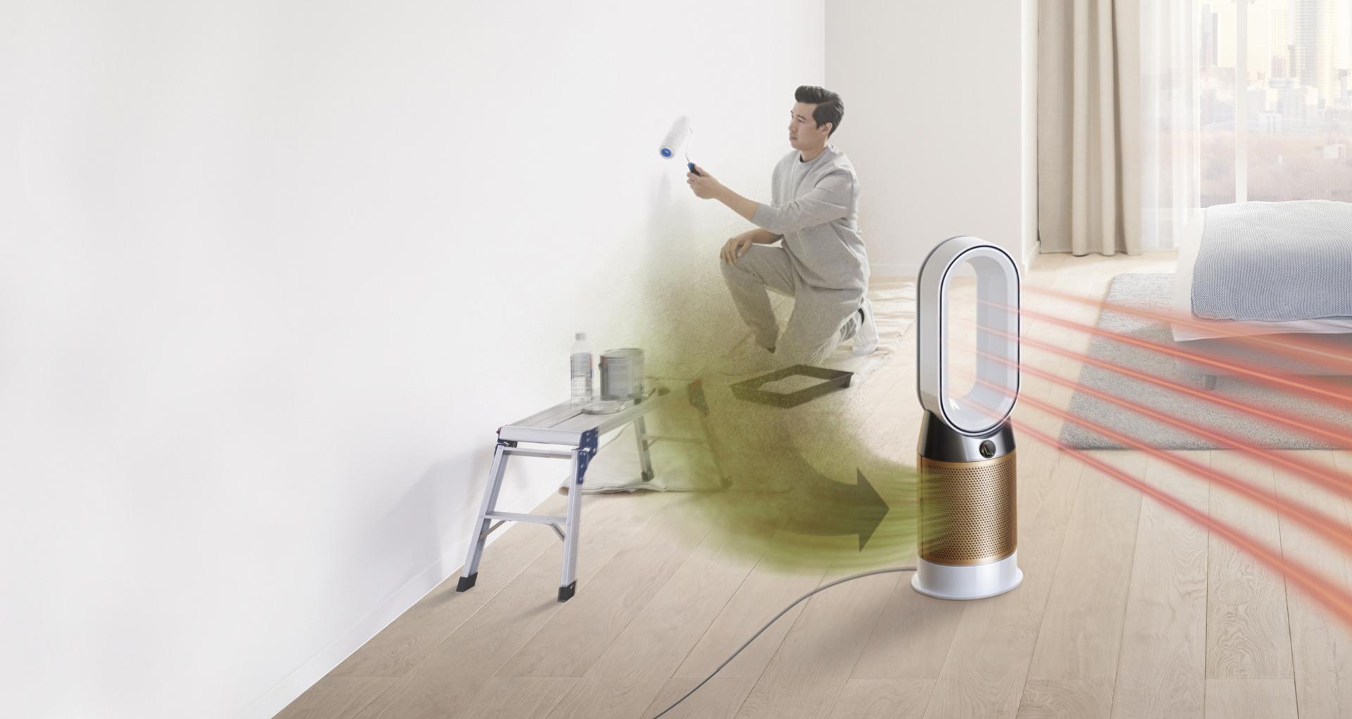 A man paints a room, while formaldehyde gas pollutes the air around him. The Dyson Pure Cryptomic purifier draws in the pollution and projects purified air.