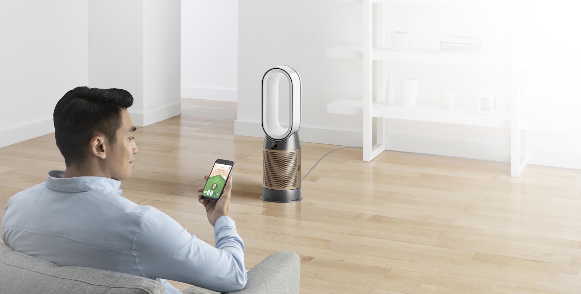 Man controlling Dyson air purifier with Dyson Link app