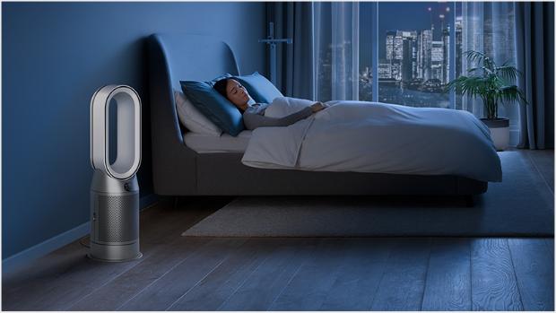 Dyson purifier in a dark bedroom with someone sleeping peacefully
