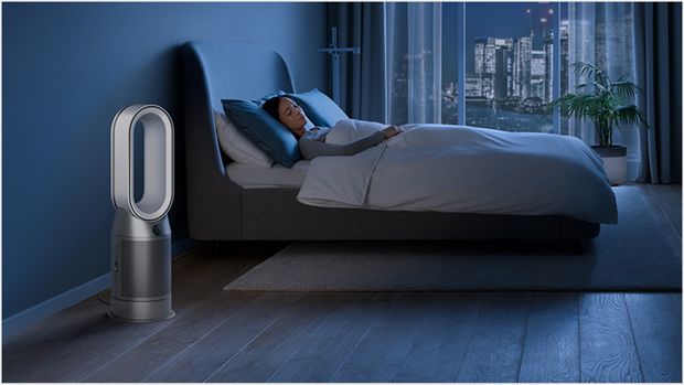 Dyson purifier in a dark bedroom with someone sleeping peacefully 