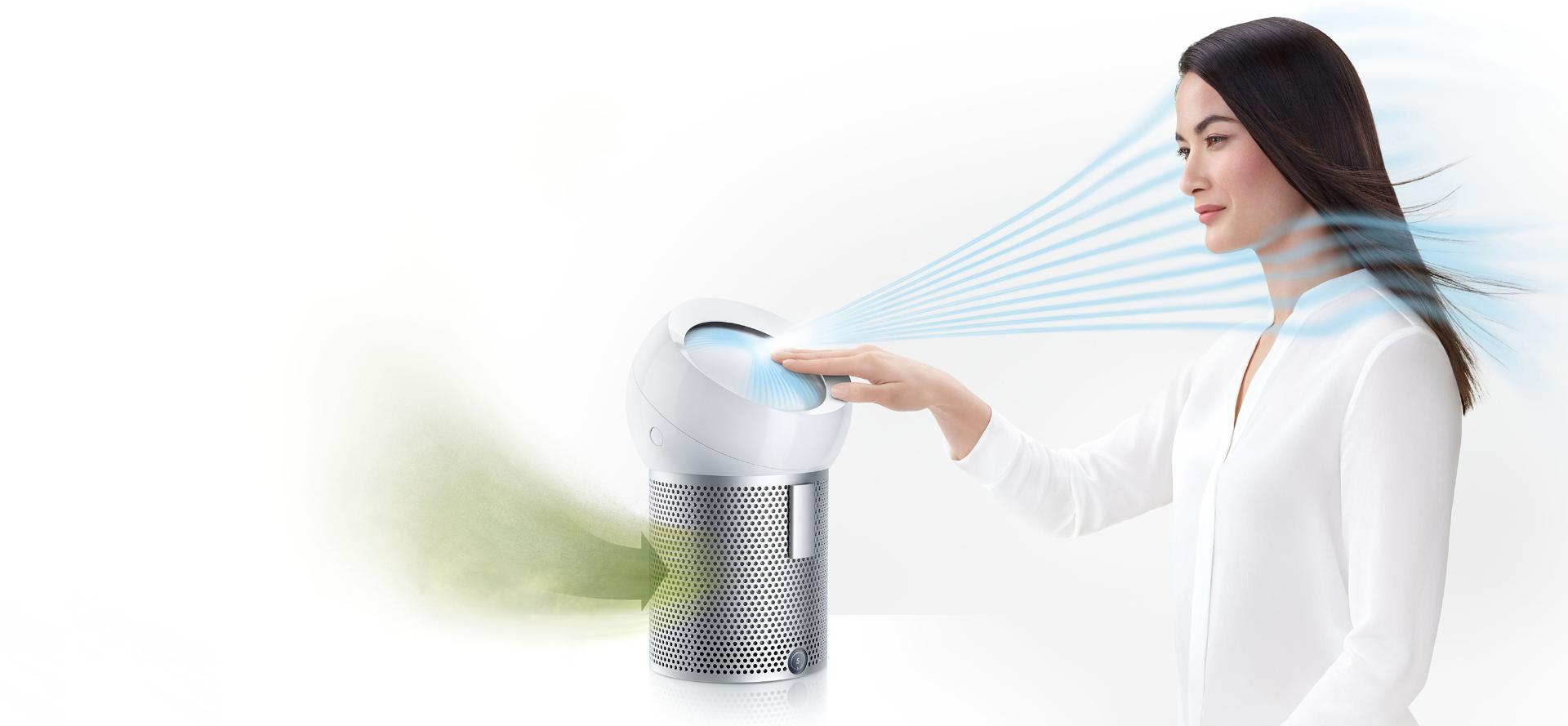 A woman using the Dyson Pure Cool Me personal purifier fan to project cooling, purified air