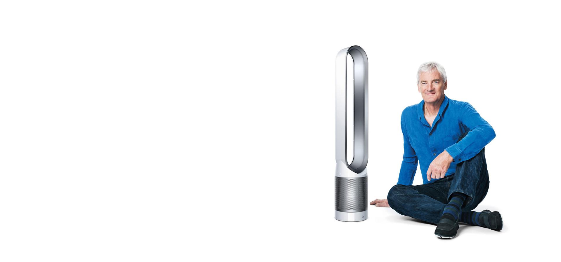 James Dyson sitting beside Dyson Pure Cool™ purifier fan