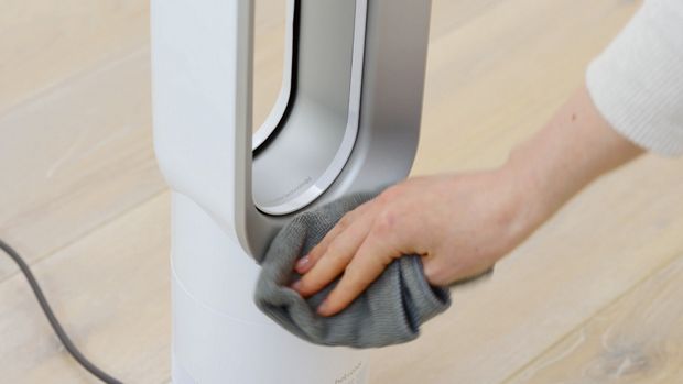 Machine owner wiping their machine clean with a cloth