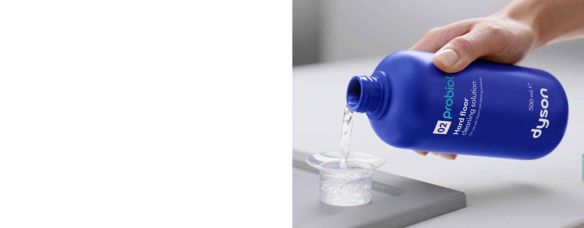 Dyson 02 Probiotic hard floor cleaning solution is poured into a measuring cup.