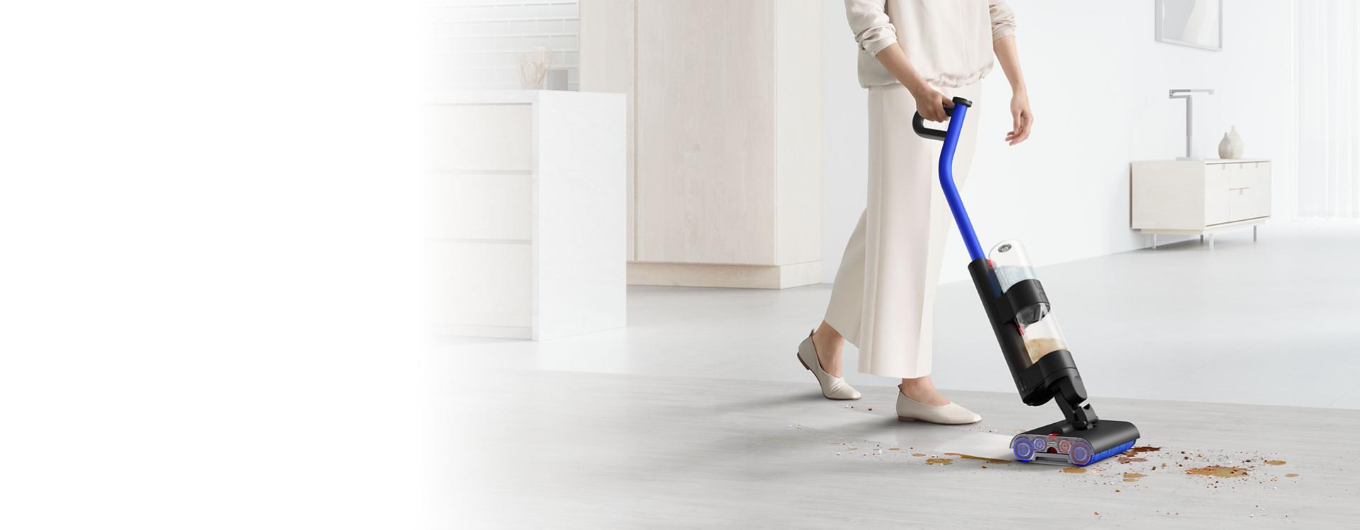 The Dyson WashG1 leaving a clean sweep through mess on a hard kitchen floor