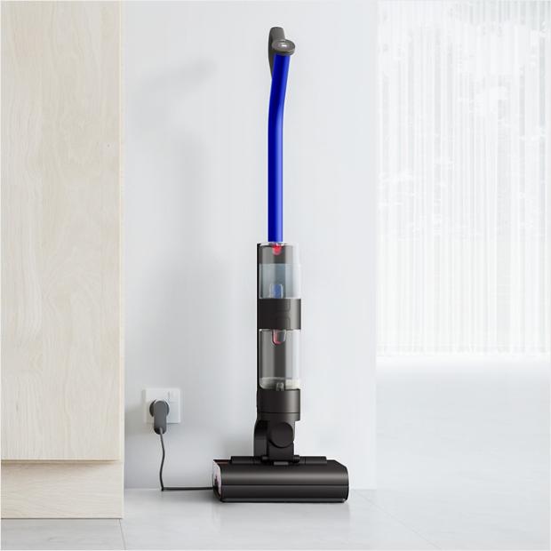 The Dyson WashG1 standing and charging on the floor dock