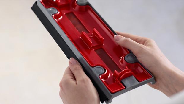 A user holding the Debris tray