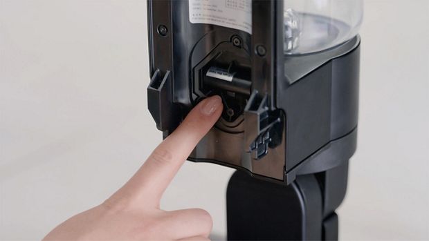 A user pointing to where the Check valve and cover have been removed