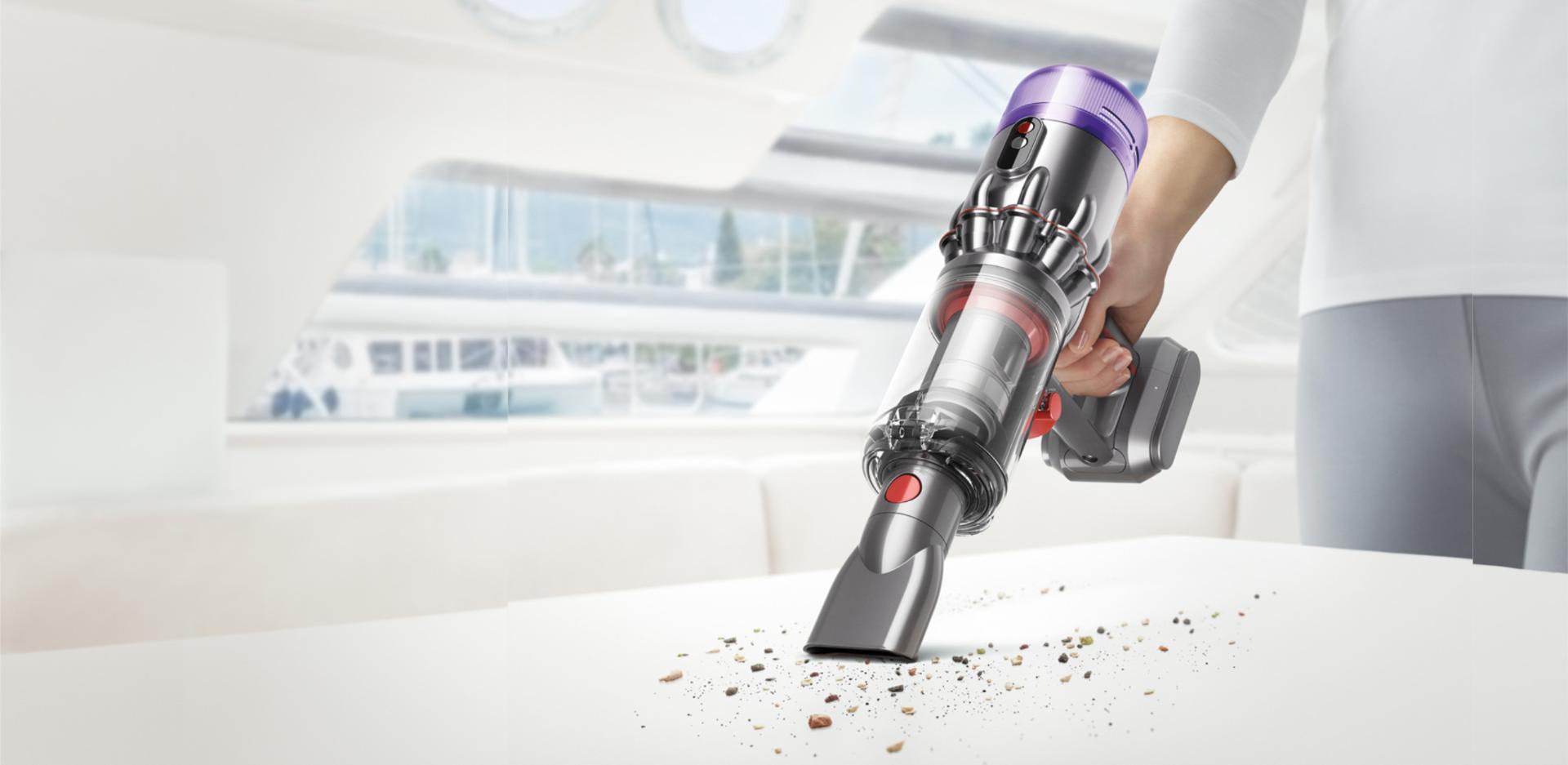 A woman assembling the Dyson Micro handheld vacuum cleaner.