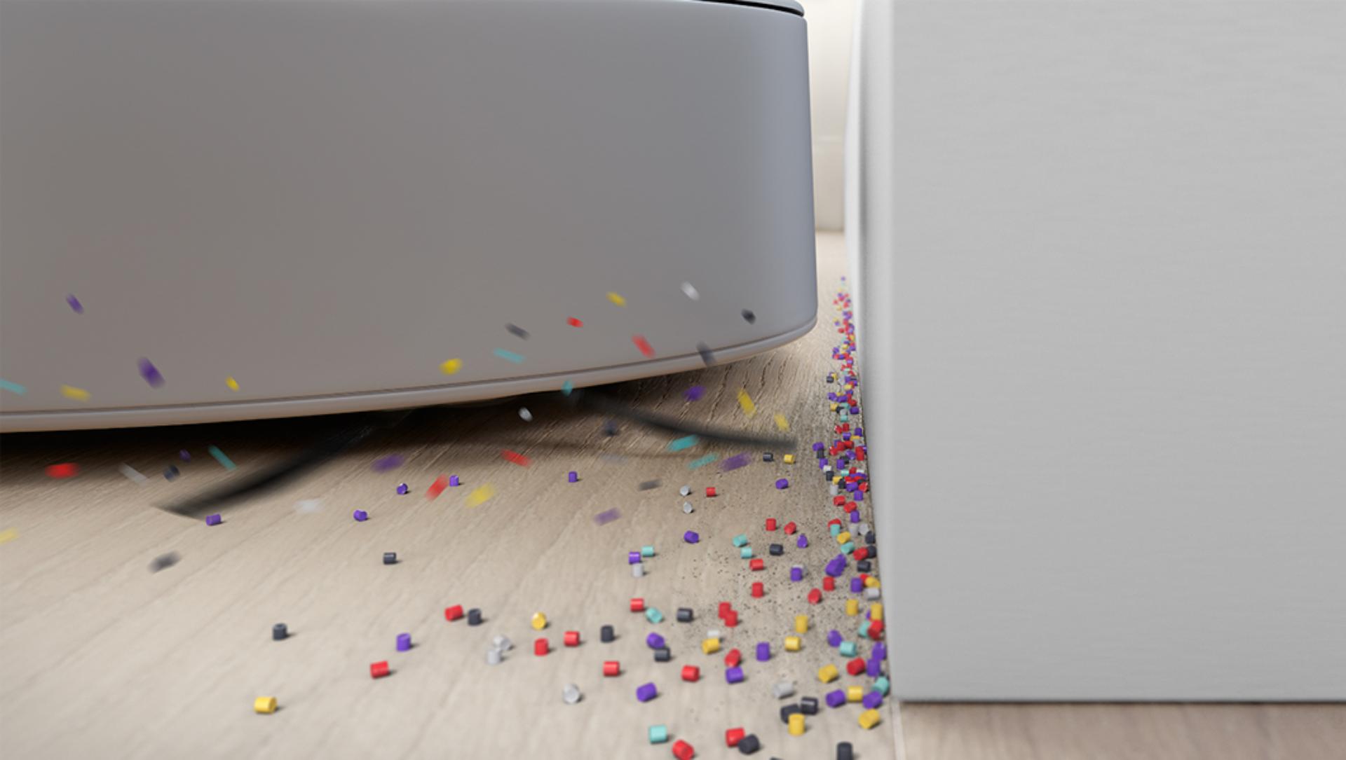 備有側面清掃器的吸塵機械人四處拂起碎屑。