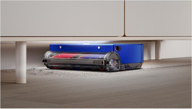 Dyson 360 Vis Nav using its low profile and LED light ring to clean under furniture