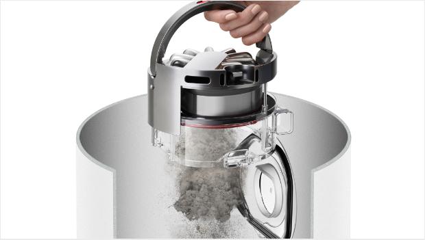 Woman using the robot's hygienic ejection mechanism into a bin