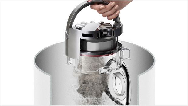 Woman using the robot's hygienic ejection mechanism into a bin