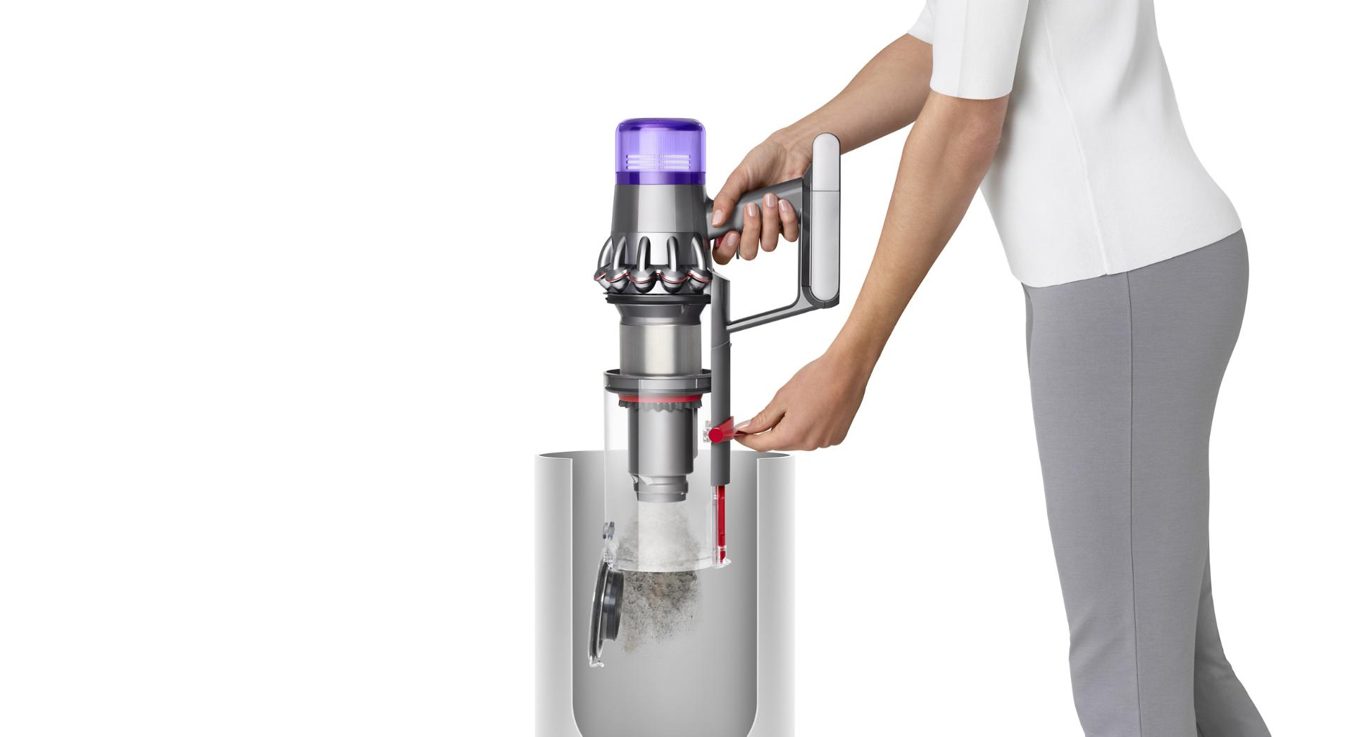 Woman emptying Dyson V11™ vacuum into bin