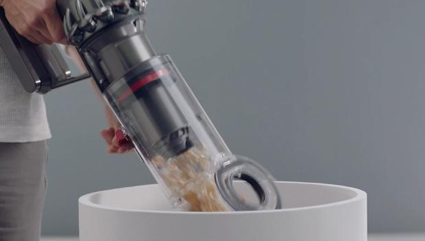 Man emptying Dyson V11™ vacuum into bin