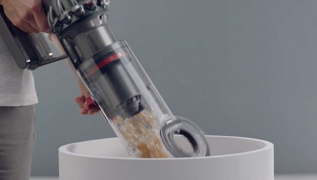 Man emptying Dyson V11™ vacuum into bin