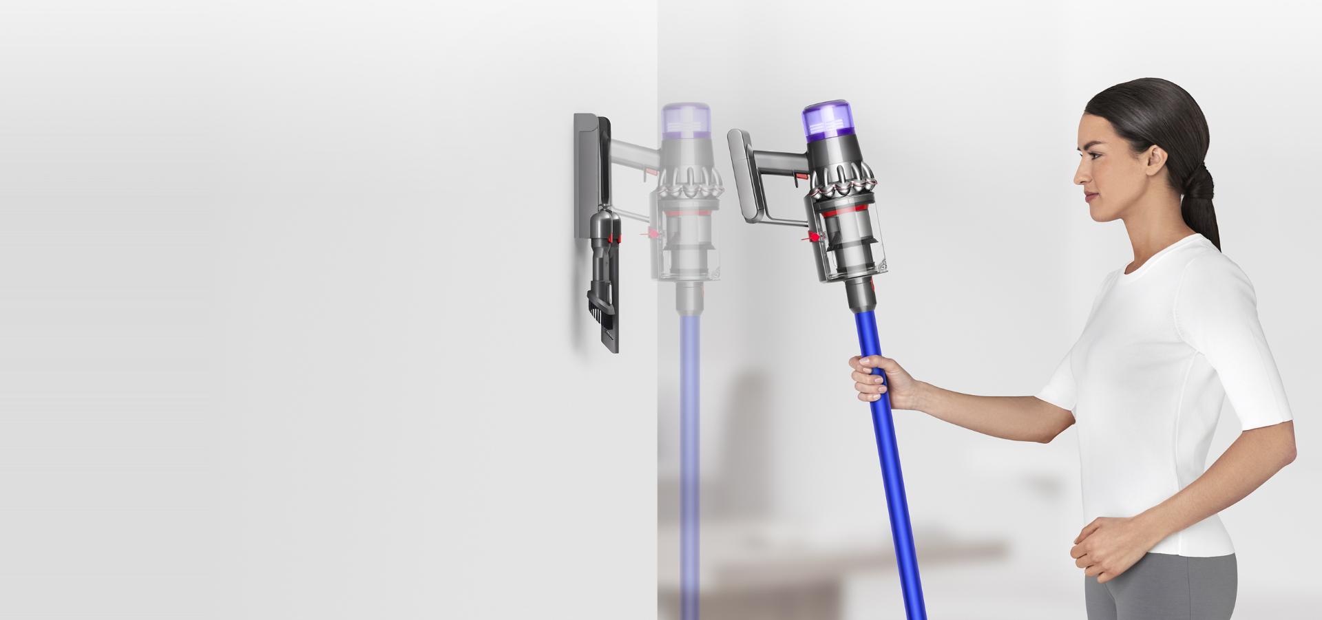 一位女士正將Dyson V11™吸塵機放入掛牆式充電座